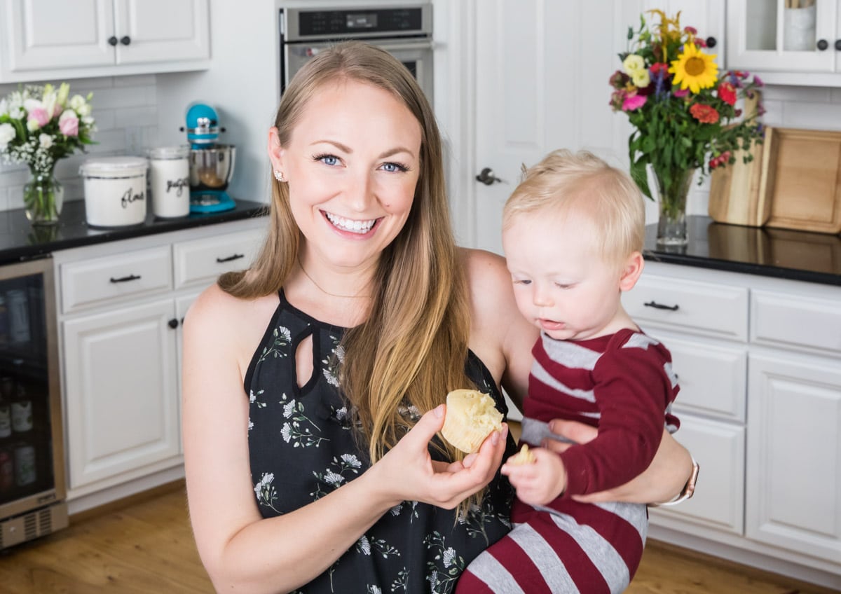 the author holding a cupcake with her baby
