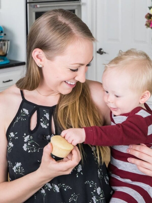 the author holding a cupcake with her baby