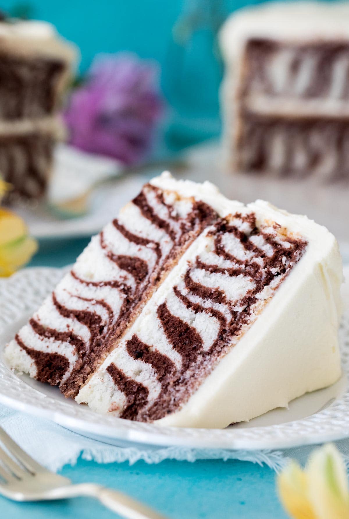 Slice of zebra cake on white plate