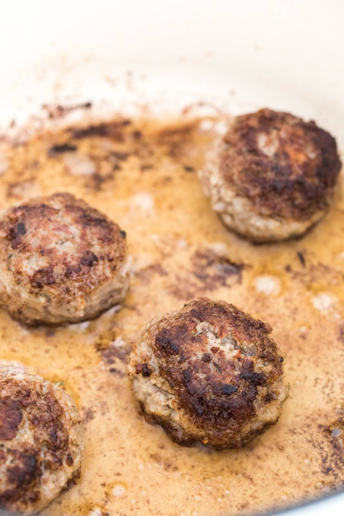 seared meatballs in pot