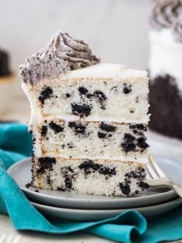 slice of three layer oreo cake on white plate