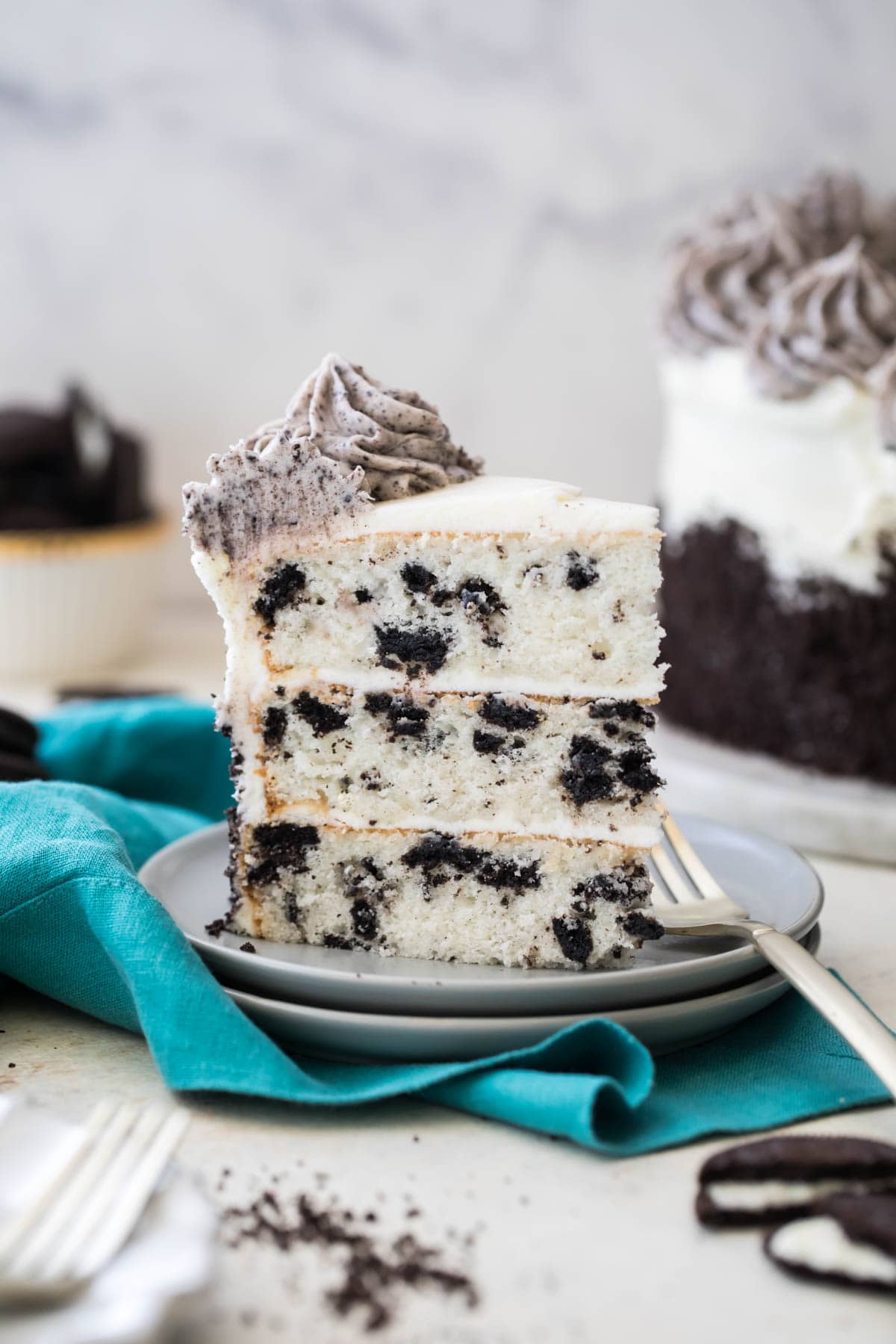 slice of three layer oreo cake on white plate