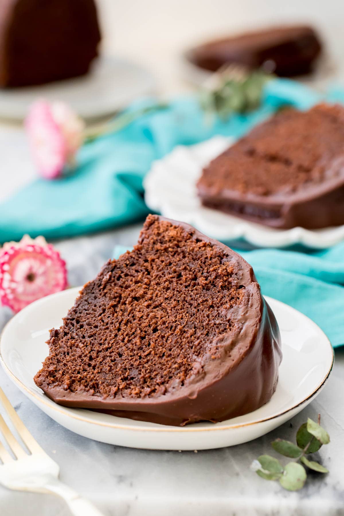 Slice of chocolate bundt cake on white plate