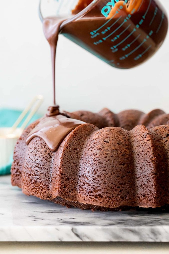 Pouring chocolate glaze over bundt cake