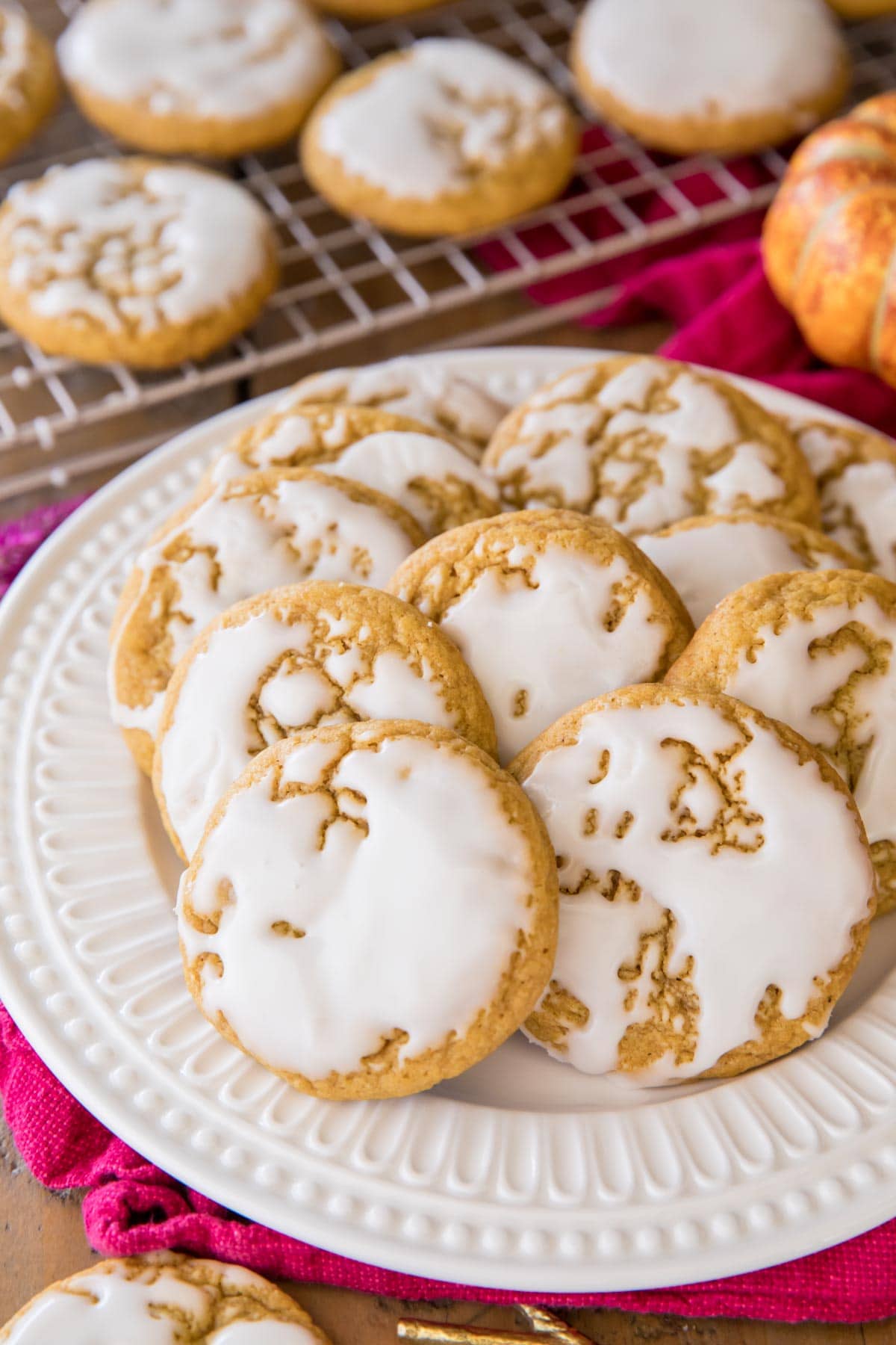 glazed pumpkin cookies on white plate