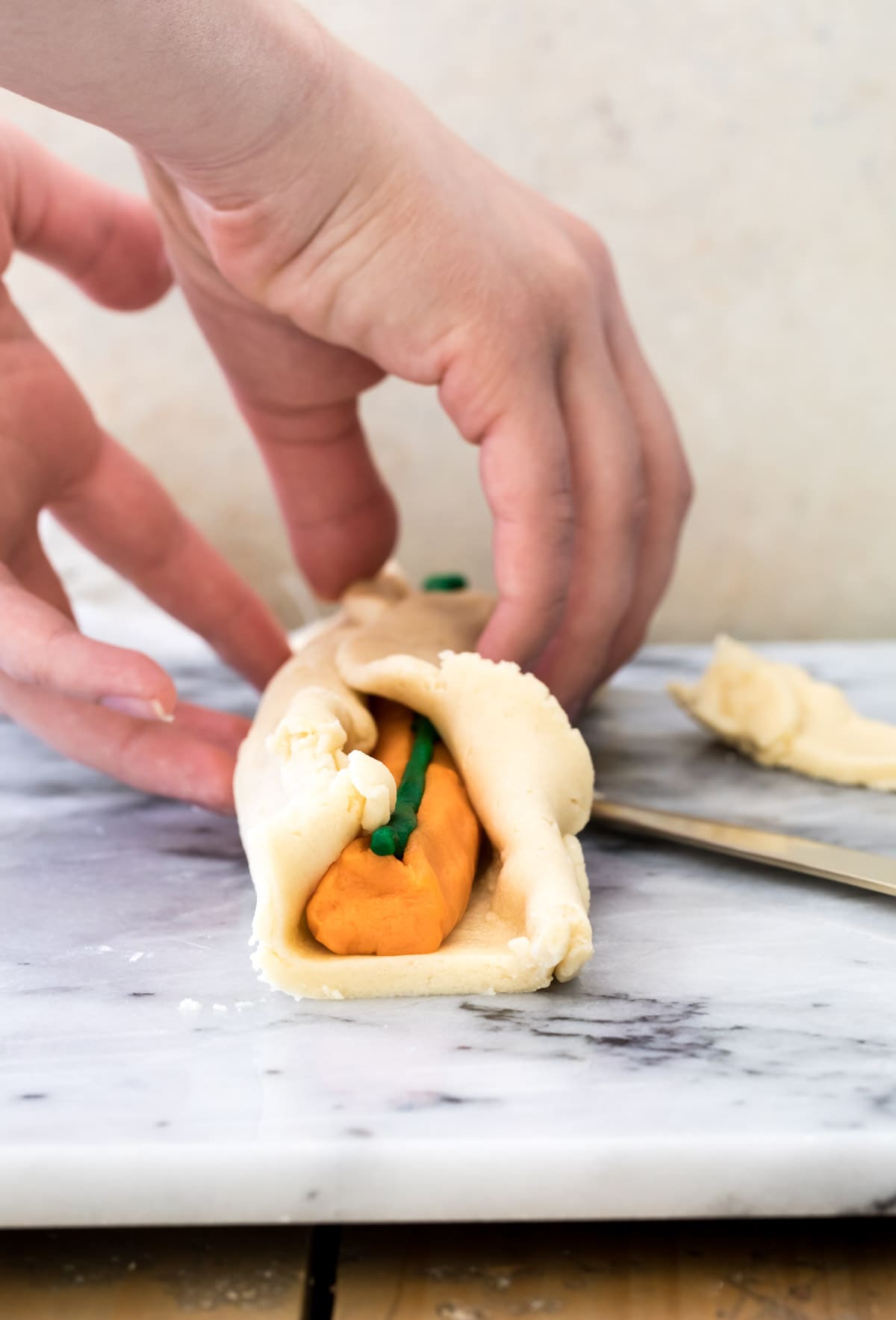 wrapping sugar cookie dough around pumpkin shaped cookie dough