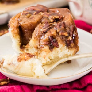 Sticky bun on white plate with fork