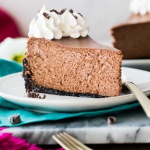 slice of chocolate cheesecake on white plate.