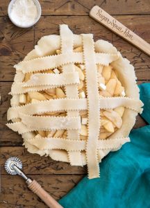 weaving a second vertical strip of pie dough