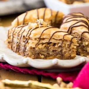 baklava with chocolate drizzle on white plate