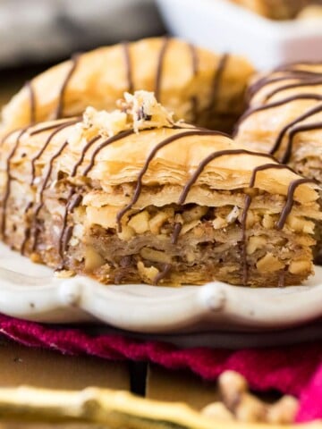 baklava with chocolate drizzle on white plate