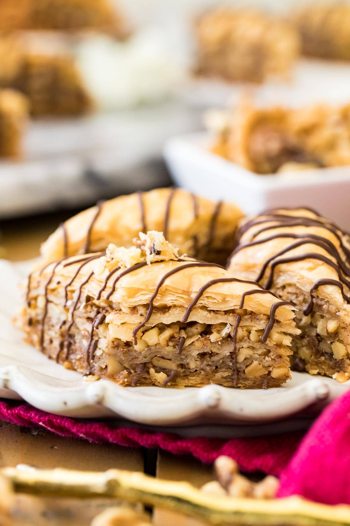 baklava with chocolate drizzle on white plate