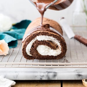 Pouring chocolate over chocolate roulade