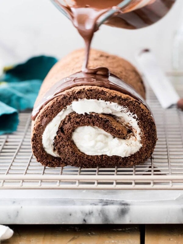 Pouring chocolate over chocolate roulade