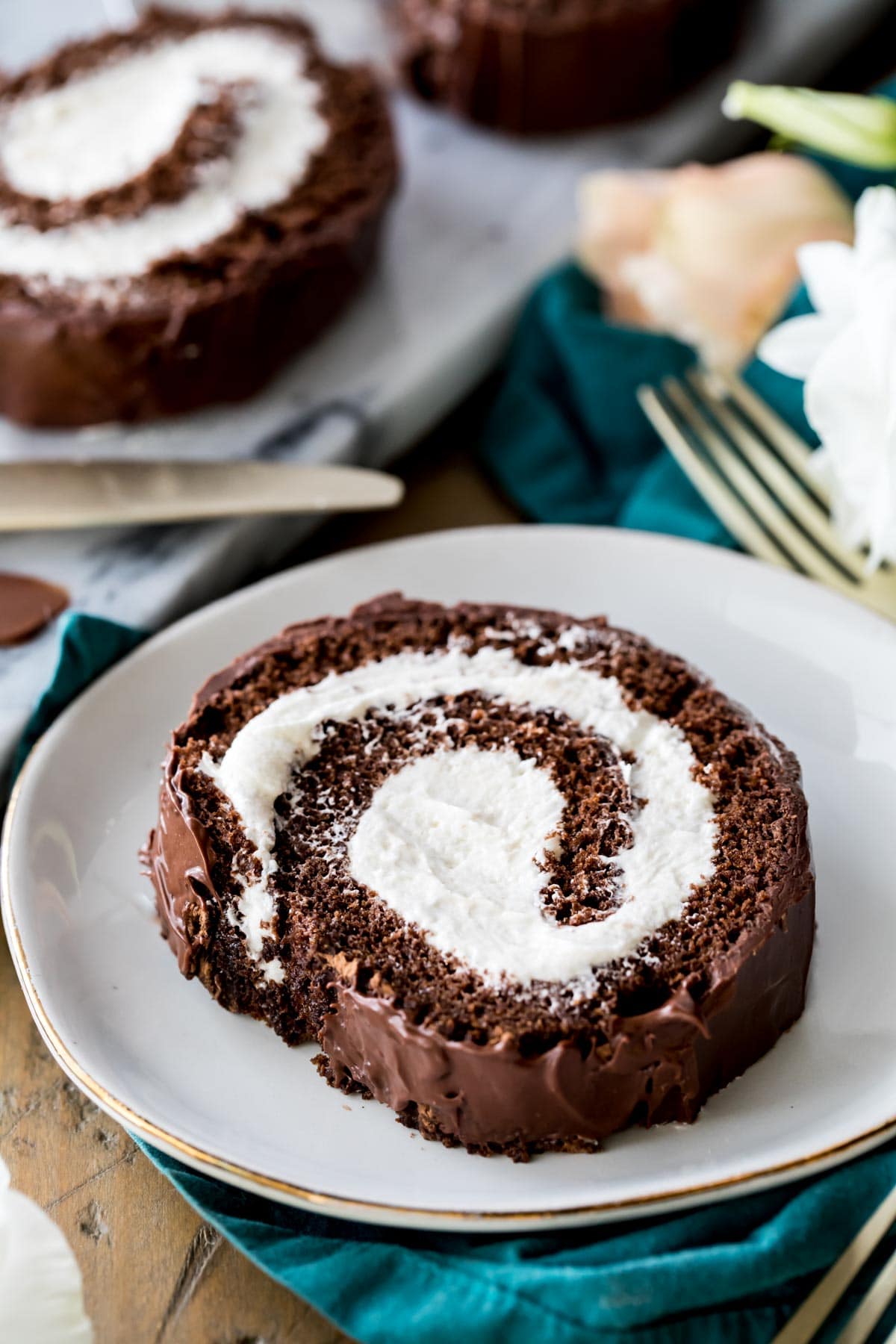 Spiral slice of Swiss roll on white plate