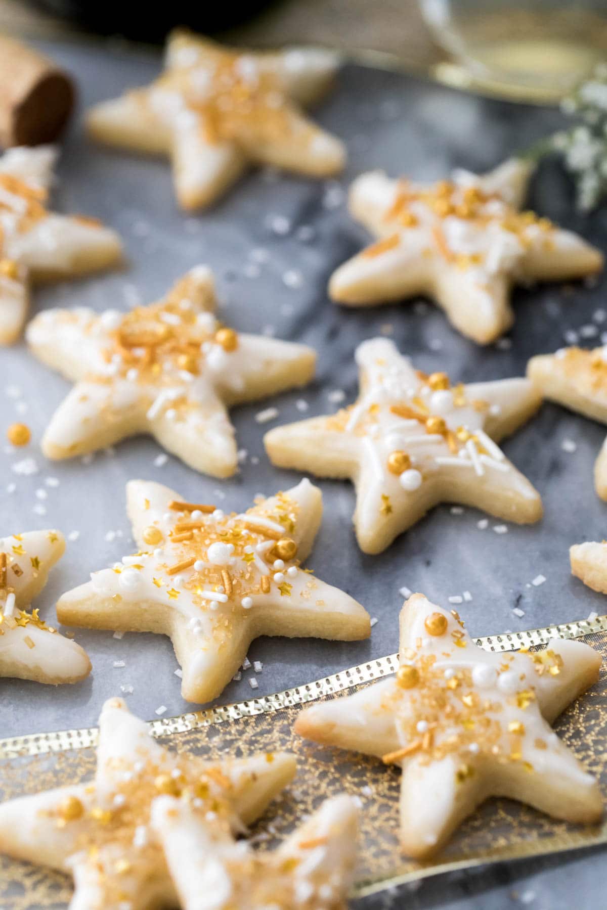 star cookies with champagne icing and sprinkles on marble