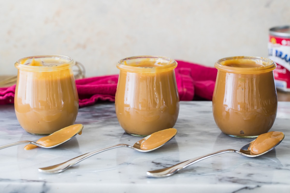 three jars of dulce de leche, each one darker than the one before it