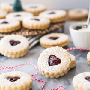 Linzer cookies on marble with red bakers twine