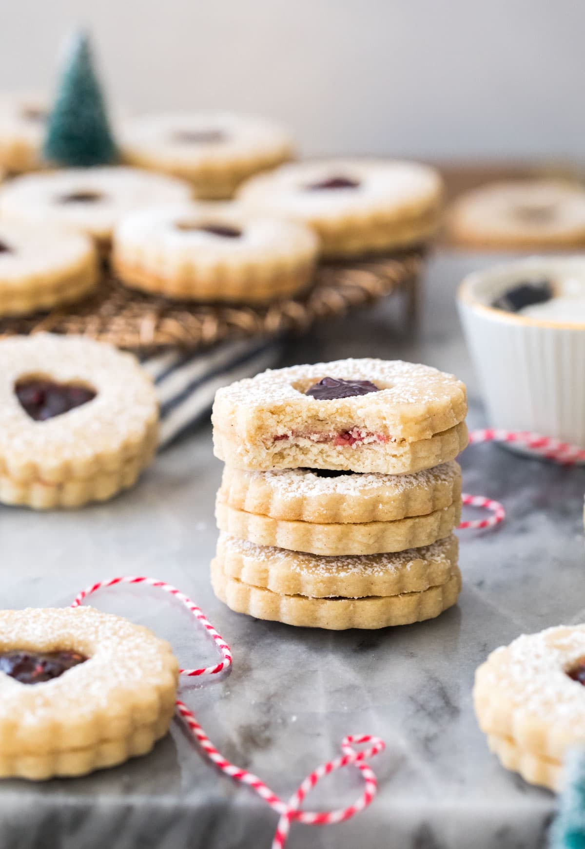 stack of linzer cookies, top one with bite out of it