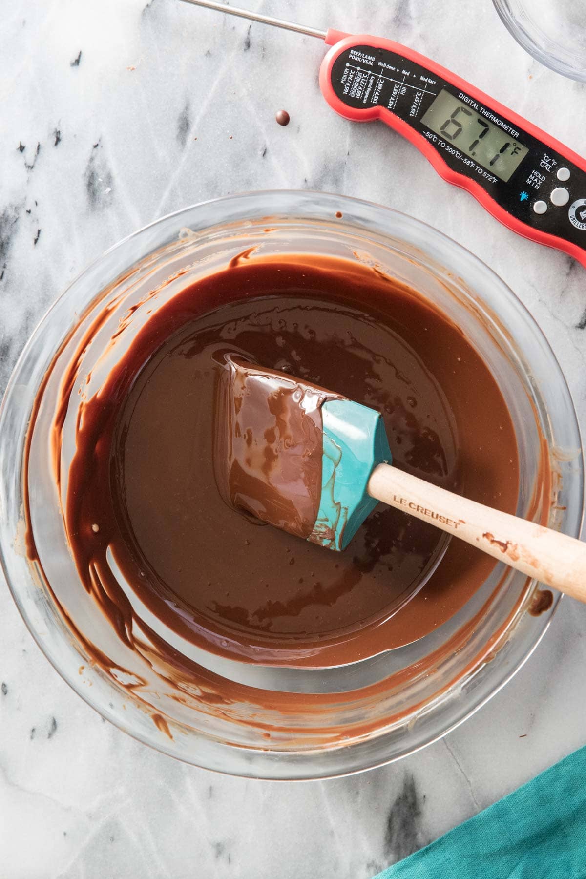 overhead of tempered chocolate in glass bowl