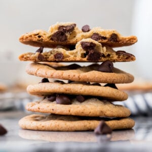 stack of thin chocolate chip cookies, white background