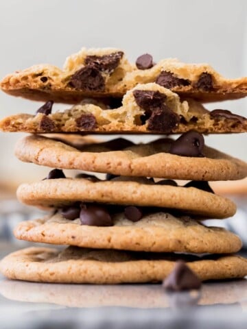 stack of thin chocolate chip cookies, white background