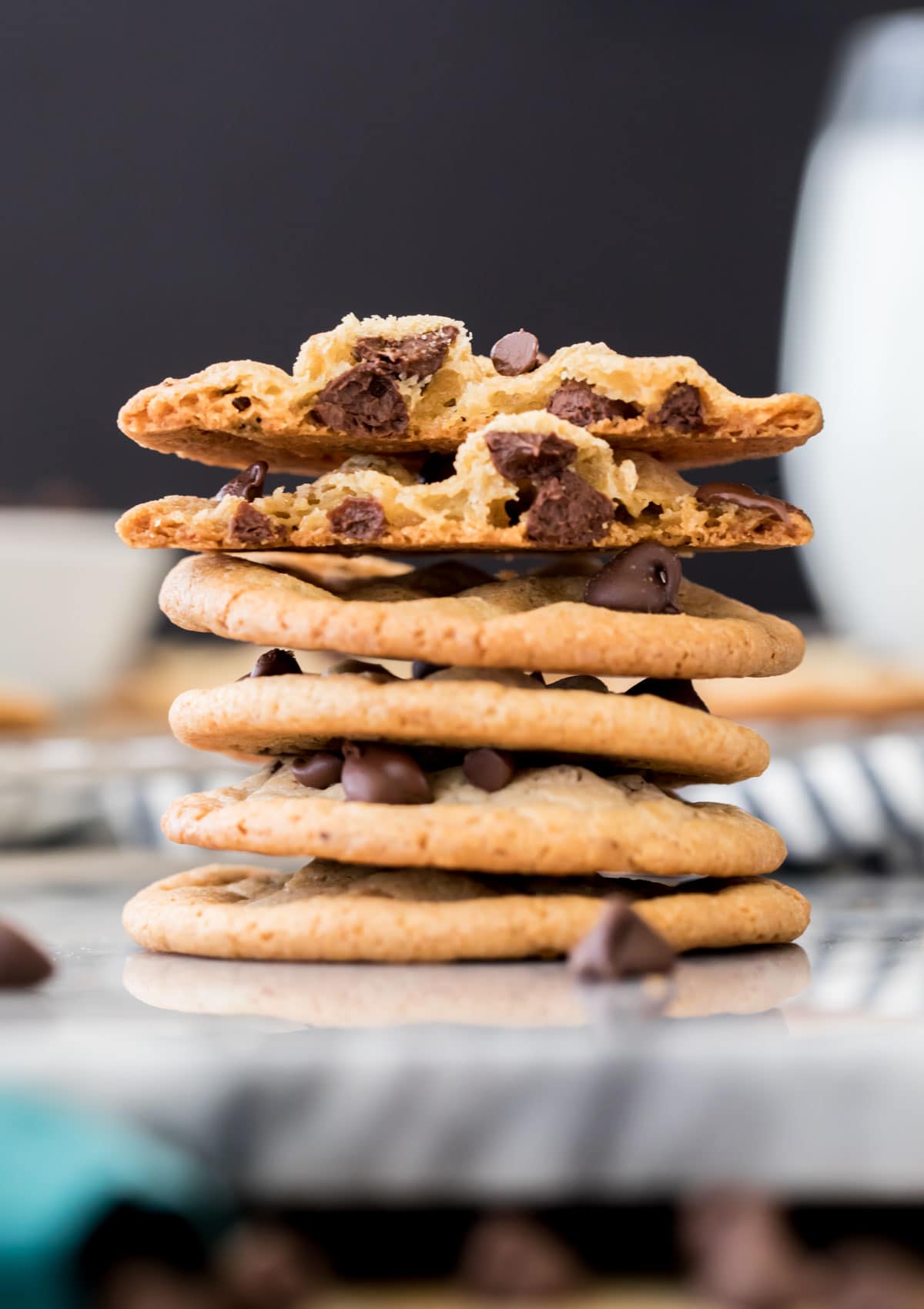 stack of thin chocolate chip cookies, black background