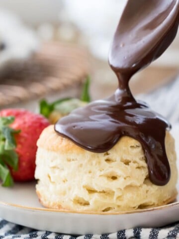 Pouring chocolate gravy over a biscuit
