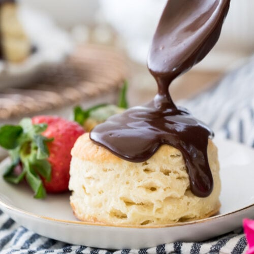 Pouring chocolate gravy over a biscuit
