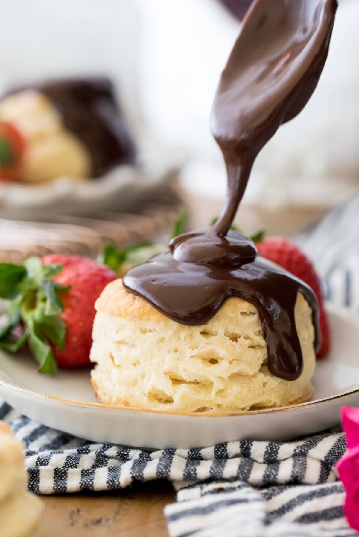 Pouring chocolate gravy over a biscuit