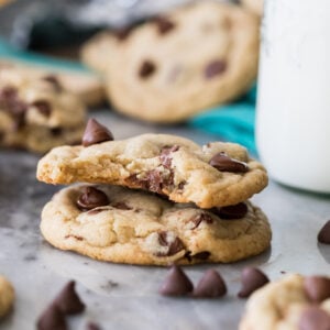 Two eggless chocolate chip cookies, one with a bite missing