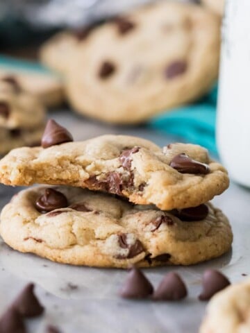 Two eggless chocolate chip cookies, one with a bite missing