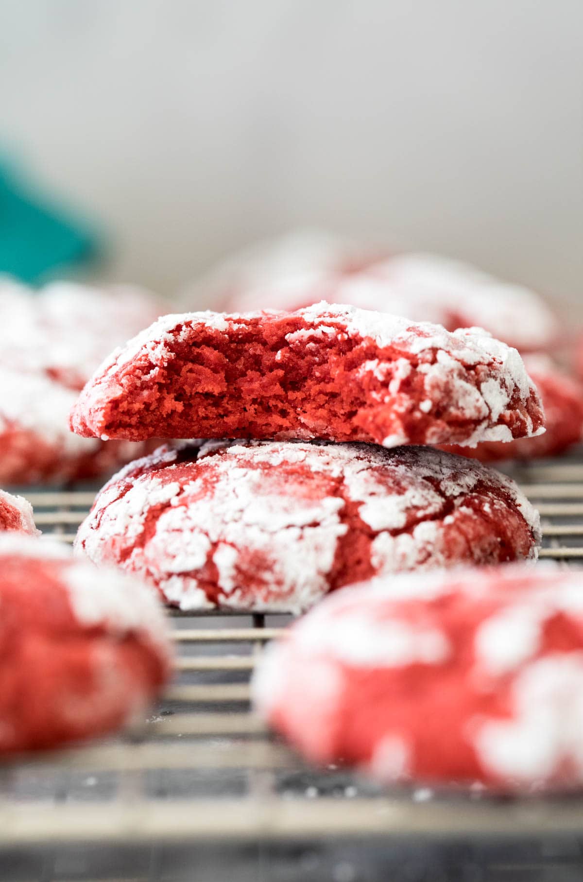 two red velvet cookies on cooling rack