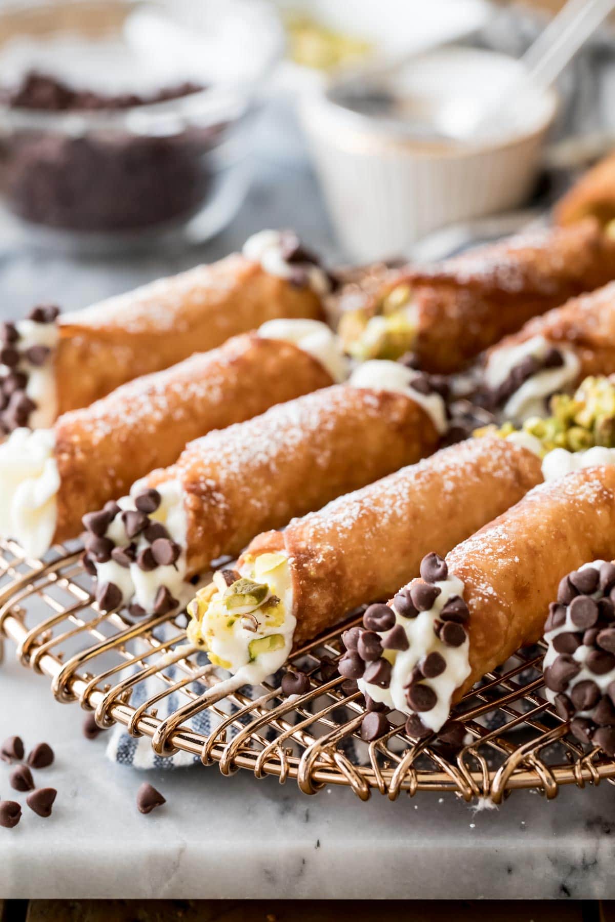 filled cannoli on gold wire rack