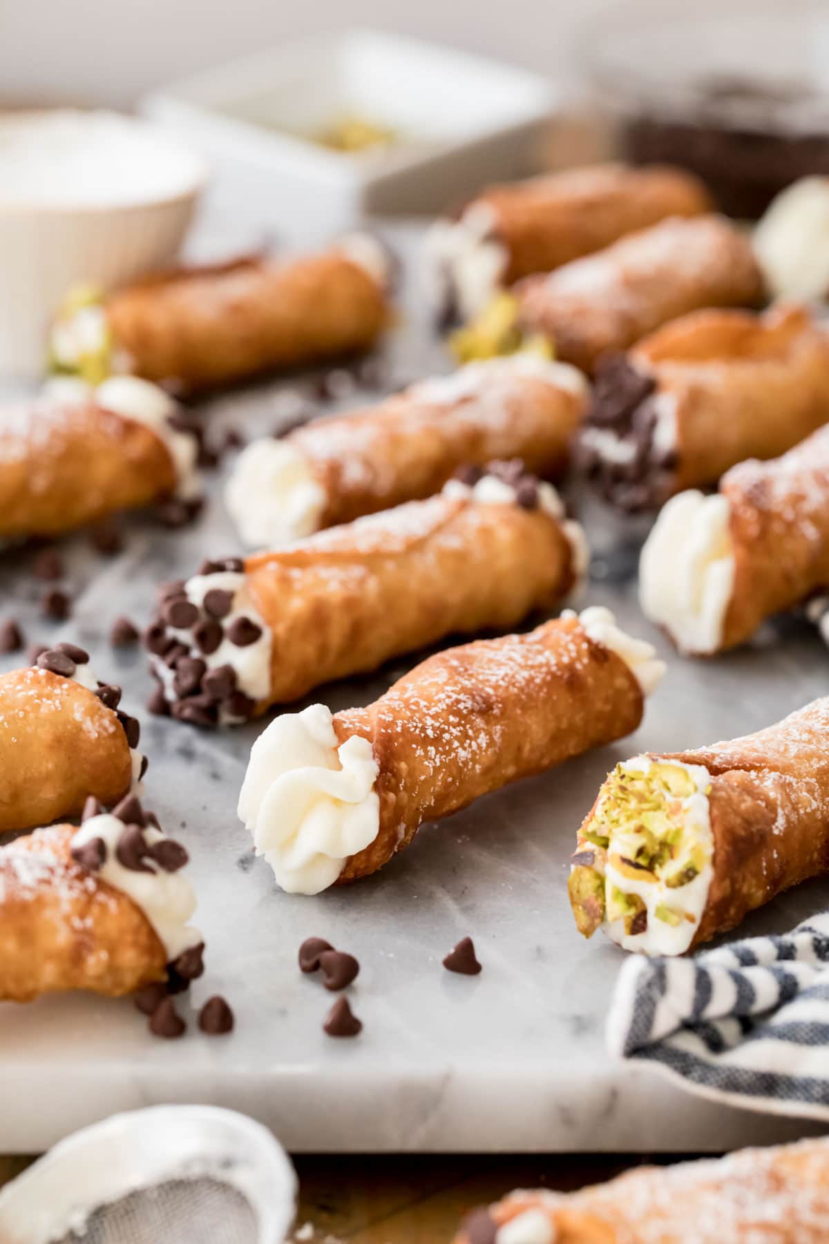 filled cannolis on marble board