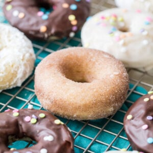 baked donuts with different toppings (chocolate frosting, cinnamon sugar, white frosting)