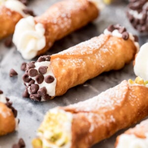 filled cannoli with chocolate chips and pistachio on marble