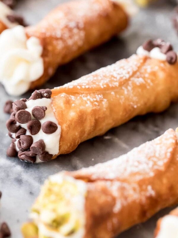 filled cannoli with chocolate chips and pistachio on marble