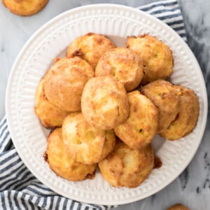 pile of cheese puffs on white plate