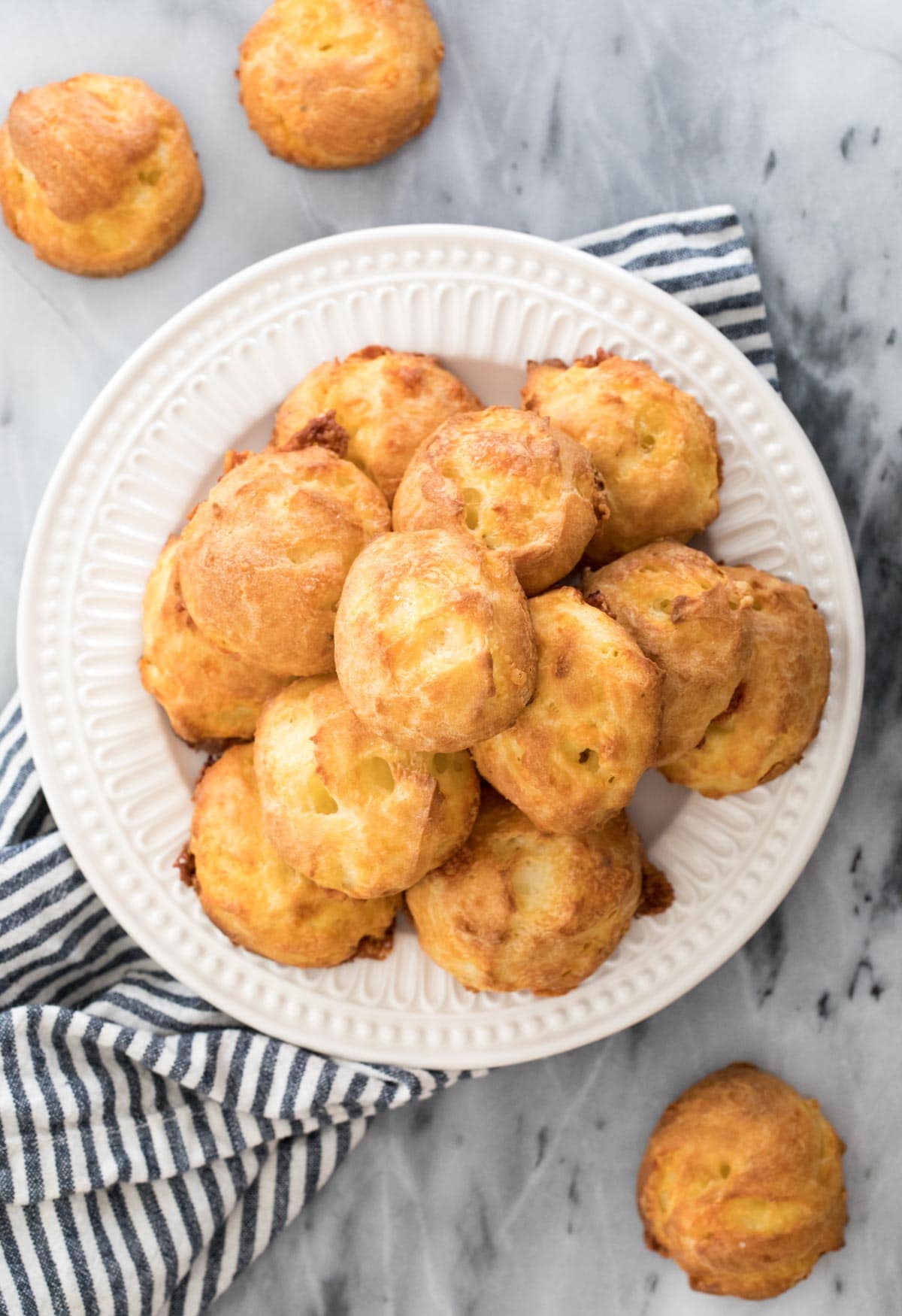 pile of cheese puffs on white plate