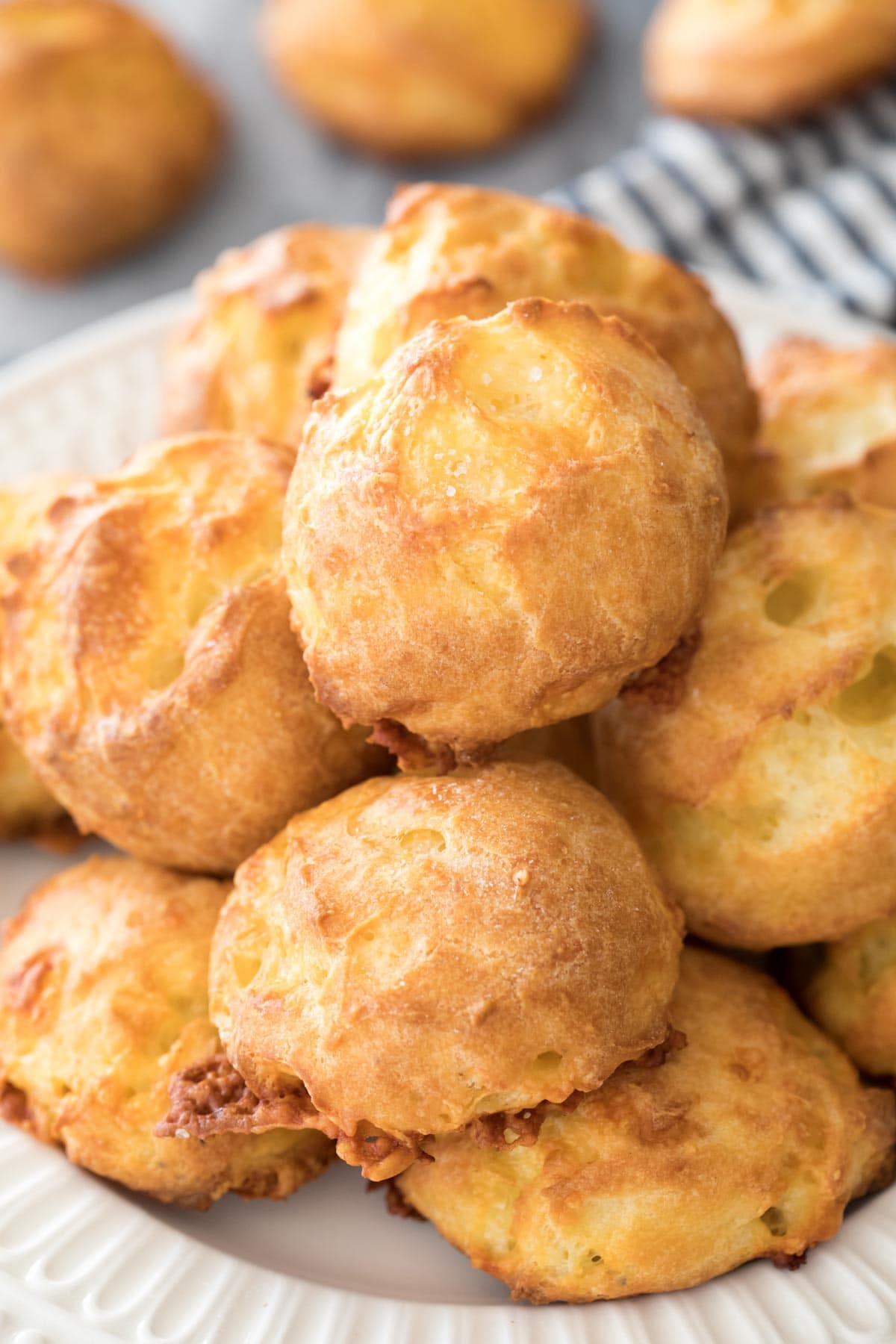 Pile of gougeres on white plate