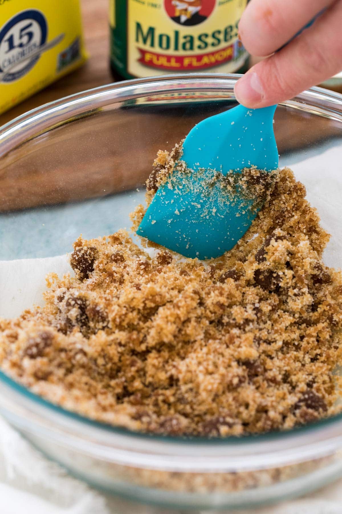 Mixing brown sugar with a blue spatula