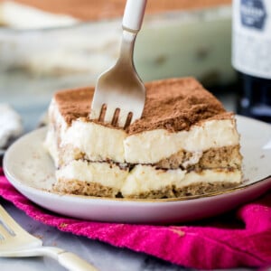 sticking a fork into a plate of tiramisu