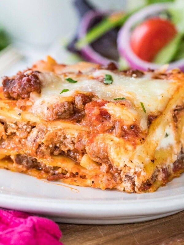 Closeup of finished lasagna showing the layers on a white plate