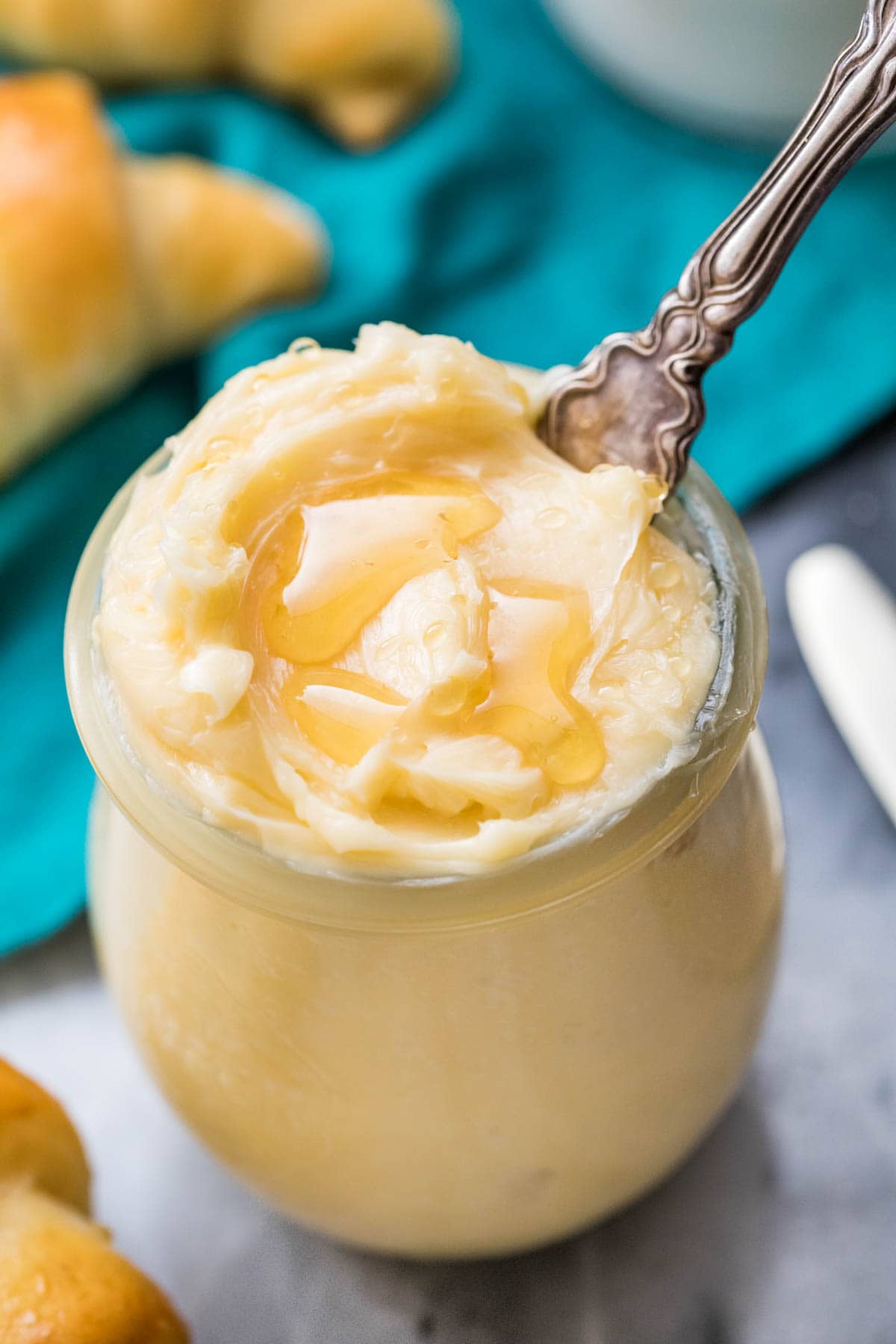 Overhead shot of honey butter in glass jar with a knife.