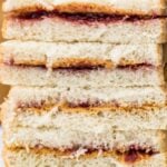 close up of peanut buter and jelly sandwiches cut in half