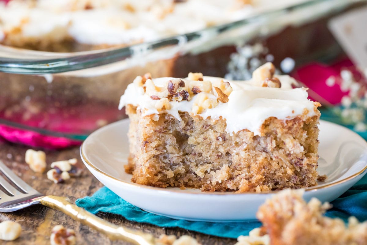 Frosted cake on a white plate.