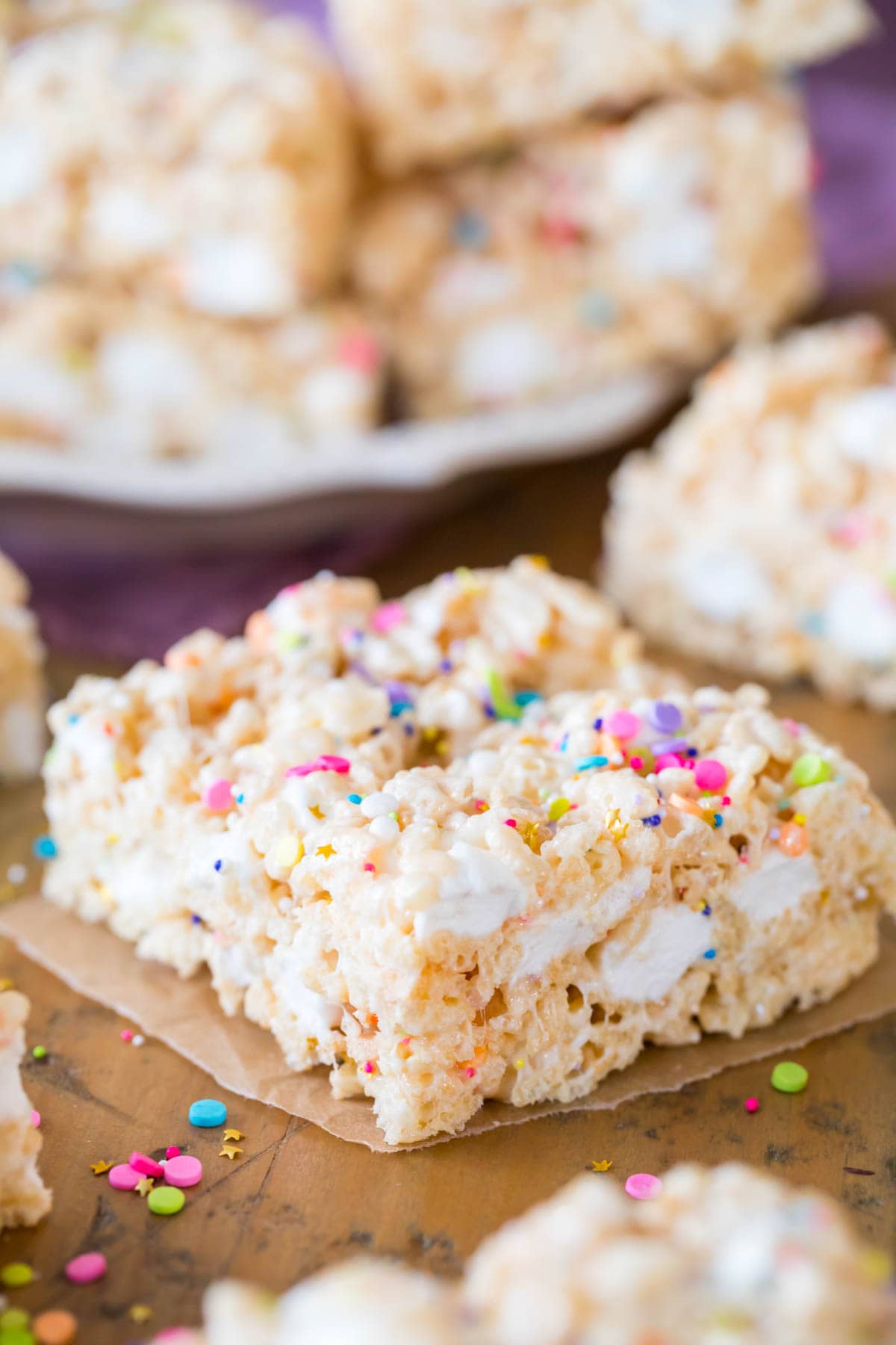 closeup of finished rice krispie treat square on wood backdrop