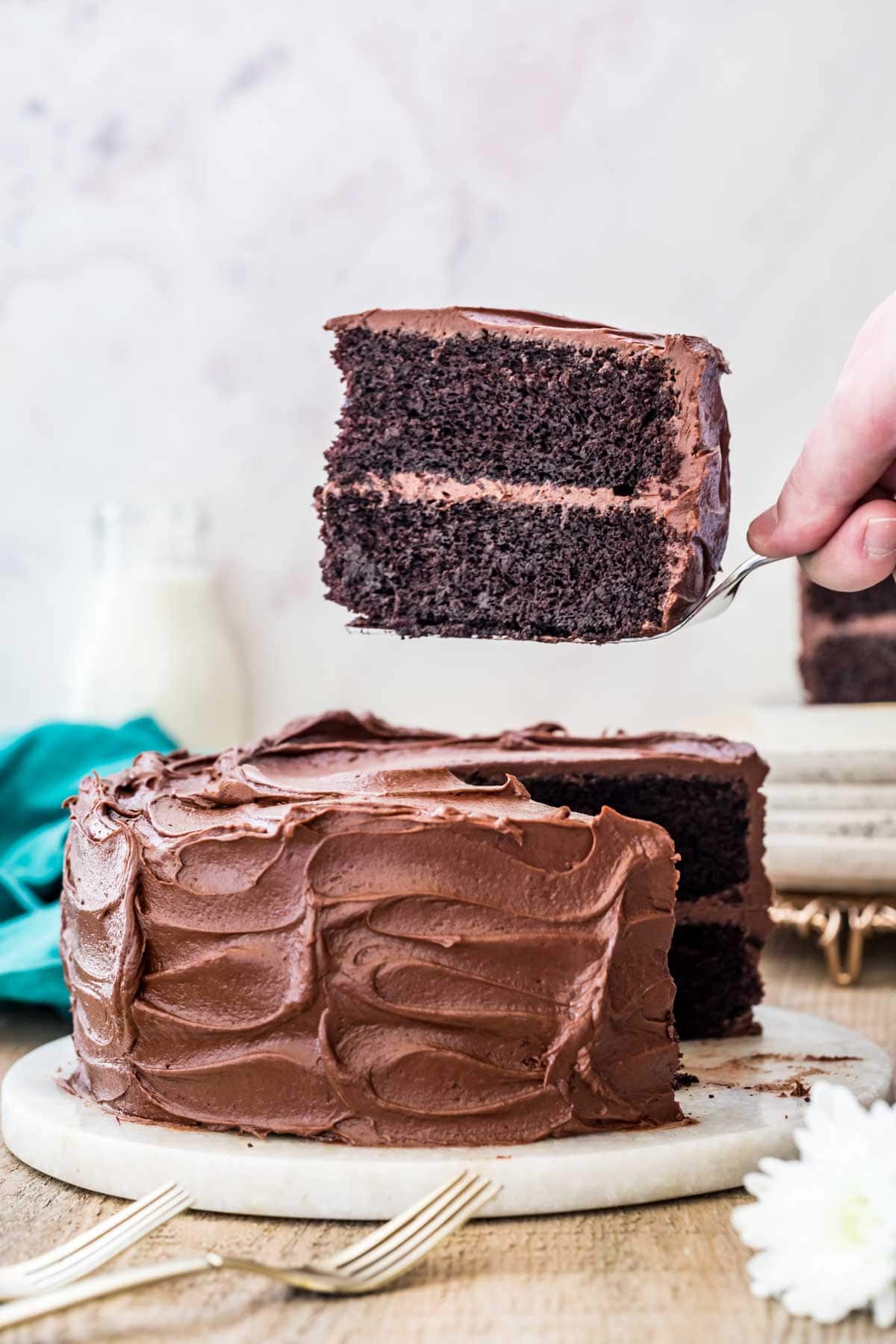 Devil's food cake with a slice being taken out