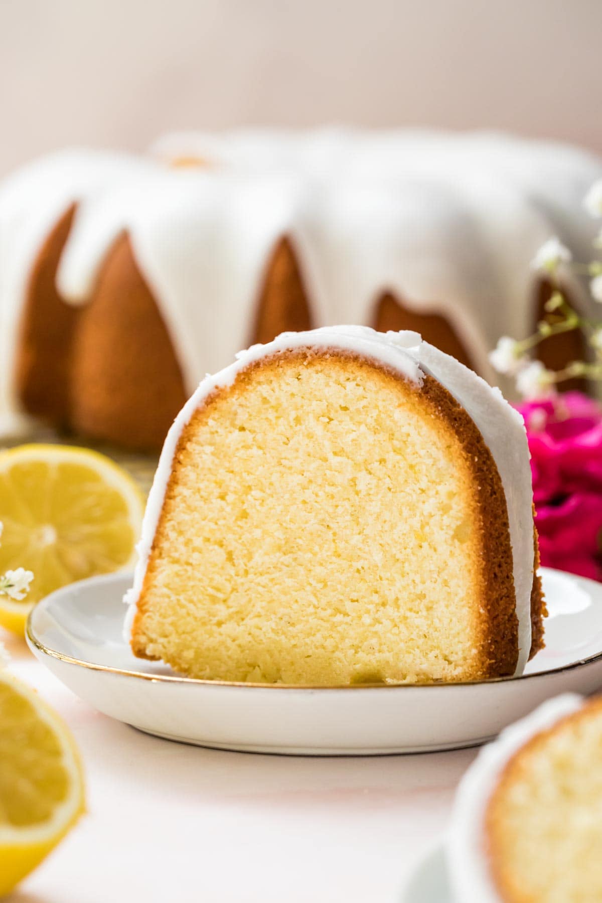 Lemon pound cake slice on a white plate.
